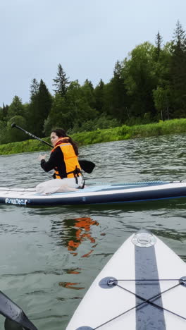 woman enjoying a paddleboarding session on a lake