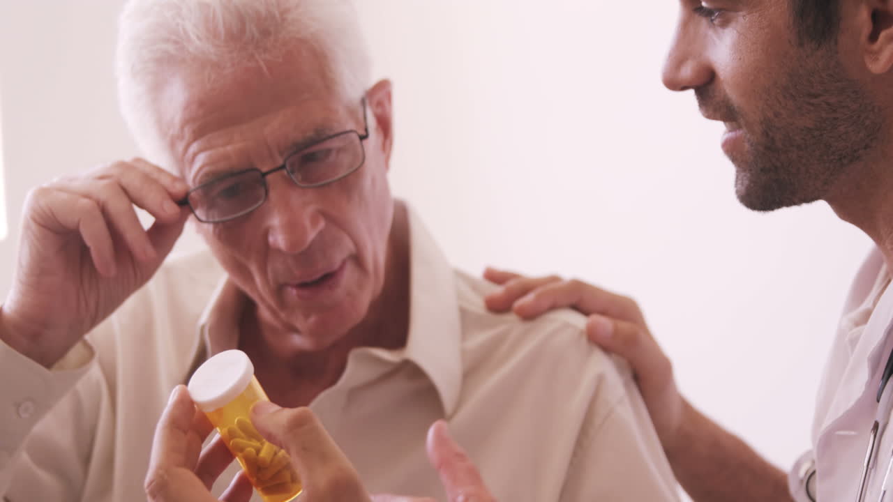 Male doctor giving prescription to senior man
