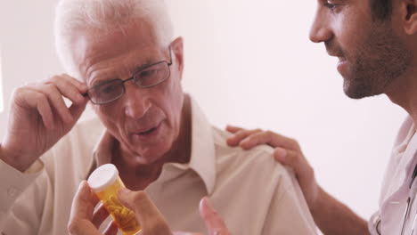 male doctor giving prescription to senior man