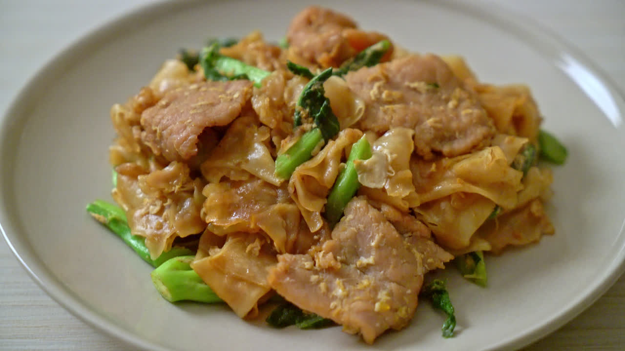 Stir-fried rice noodle with black soy sauce and pork and kale - Asian food style