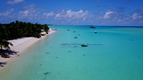 Boats-anchored-in-clear-Maldives-waters,-no-people,-aerial-forward-dolly-4k