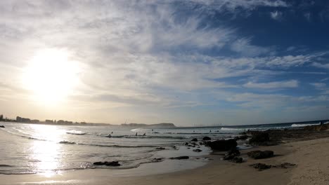 waves, surfers, and sunset at currumbin beach