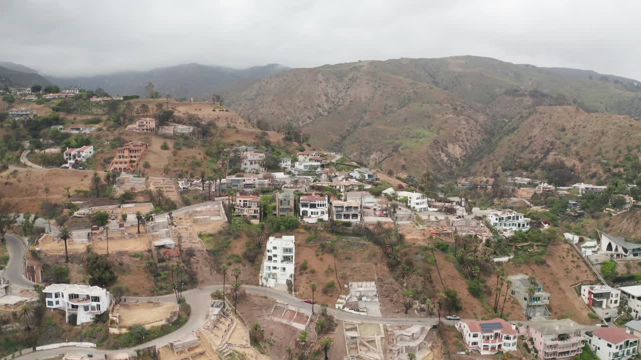 Aerial low reverse pullback shot of Las Flores Canyon after the wildfire in Malibu, California. 4K at 30 FPS