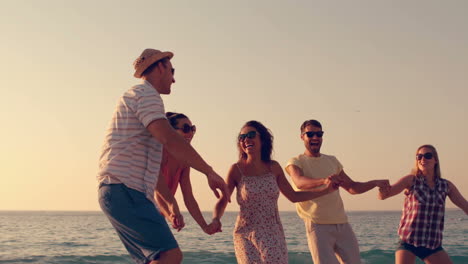 group of friends jumping together on the beach