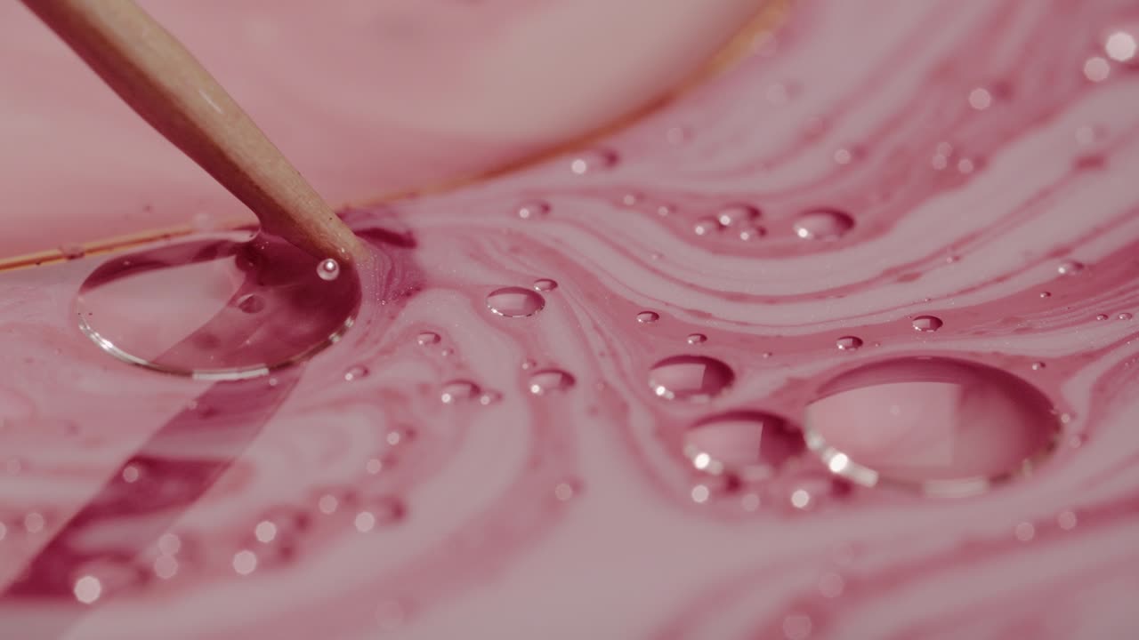 Pencil Stirring Pink Paint Surface