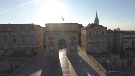 drone flying through the arc de triomphe in montpellier.