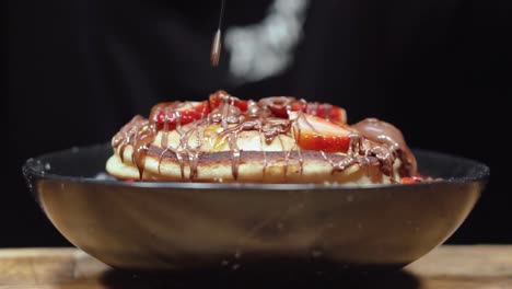 delicious pancakes with strawberries and chocolate syrup