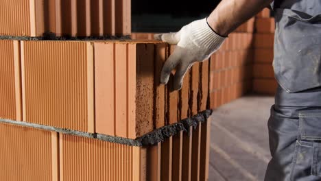 bricklayer placing bricks in a wall