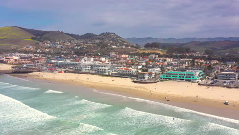 Pismo-Beach-hotels,-landscape,-sandy-shore-and-amazing-horizon-on-a-picturesque-day---wide-angle-aerial-view