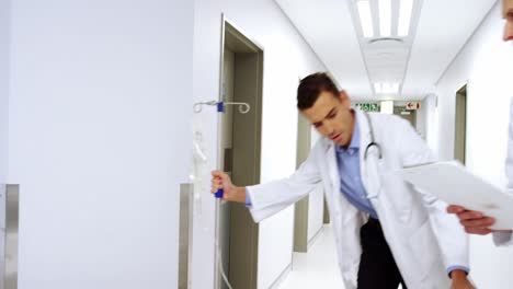 doctors pushing emergency stretcher bed in corridor