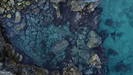 4k aerial ocean coast in sardinia, mussareddu with stones and clear water