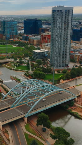 south platte river flowing through gorgeous denver, colorado, usa. panorama of the city on gloomy daytime from aerial view. vertical video