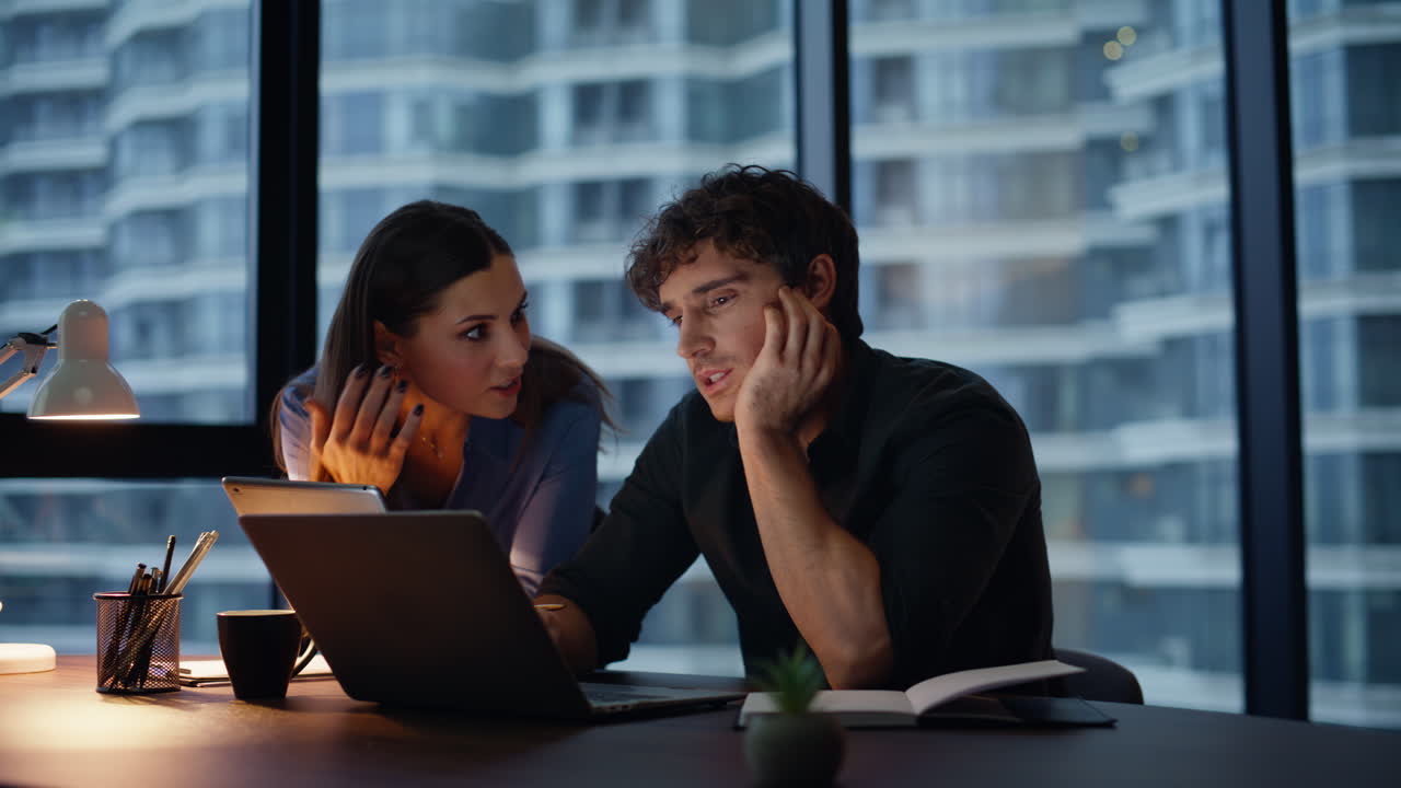 Evening colleagues brainstorming project looking laptop closeup. Two coworkers