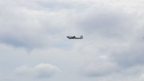 silver and blue douglas dc3 performs at baltic international airshow, carrying out flypast, view from the ground, handheld 4k shot