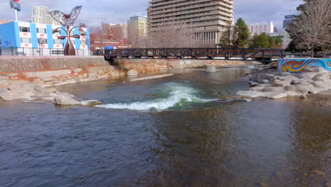 aerial over truckee river in downtown reno with a pedestrian bridge