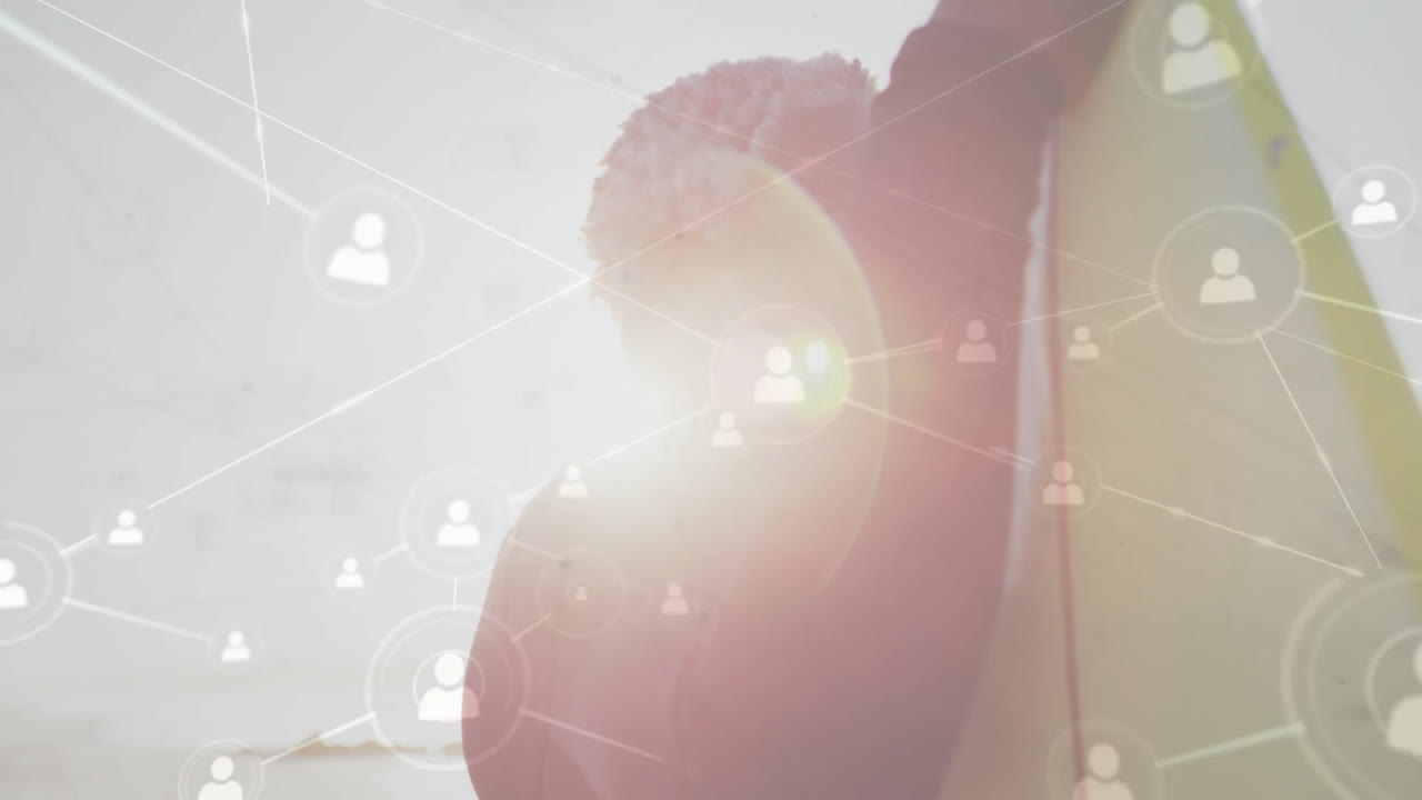Network of connections animation over person holding surfboard at beach
