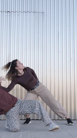 female dancers performing modern choreography in urban setting