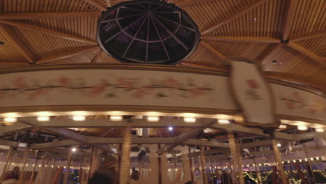 top part of fast spinning carousel with warm lights, interior