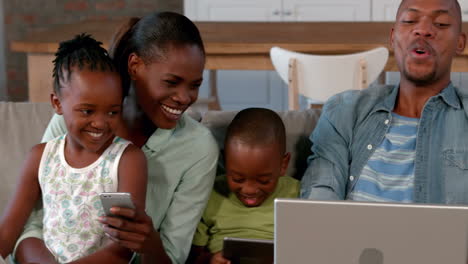 Family-using-media-devices-on-the-couch