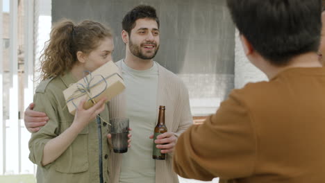 a young caucasian couple receives a gift from friends