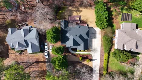 top down aerial view of luxury houses with gardens and nature area