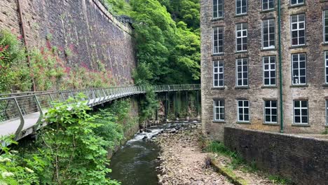 the millennium walkway in the town of new mills with the goyt river running through the video and the torr vale mill on the right