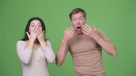 young couple looking shocked together