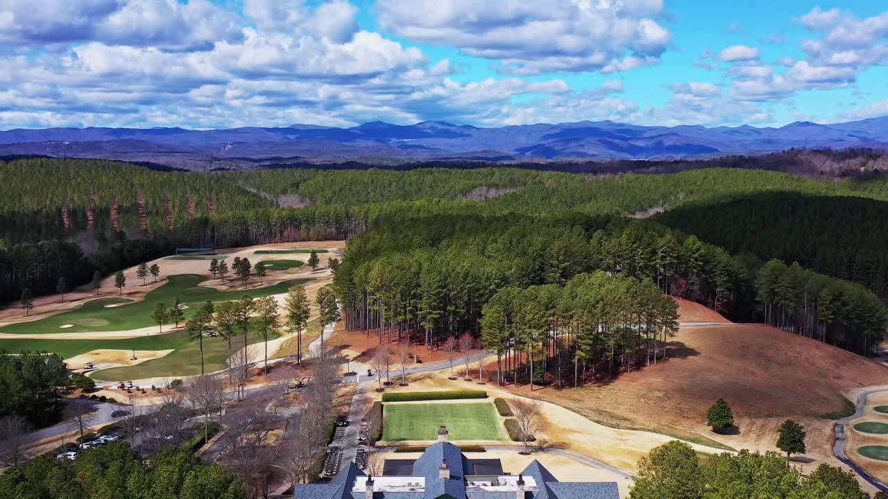 Drone shows stunning view of the Jack Nicklaus Signature Golf Course and club house at the Reserve at Lake Kiwi. Blue Ridge Mountains in background.
