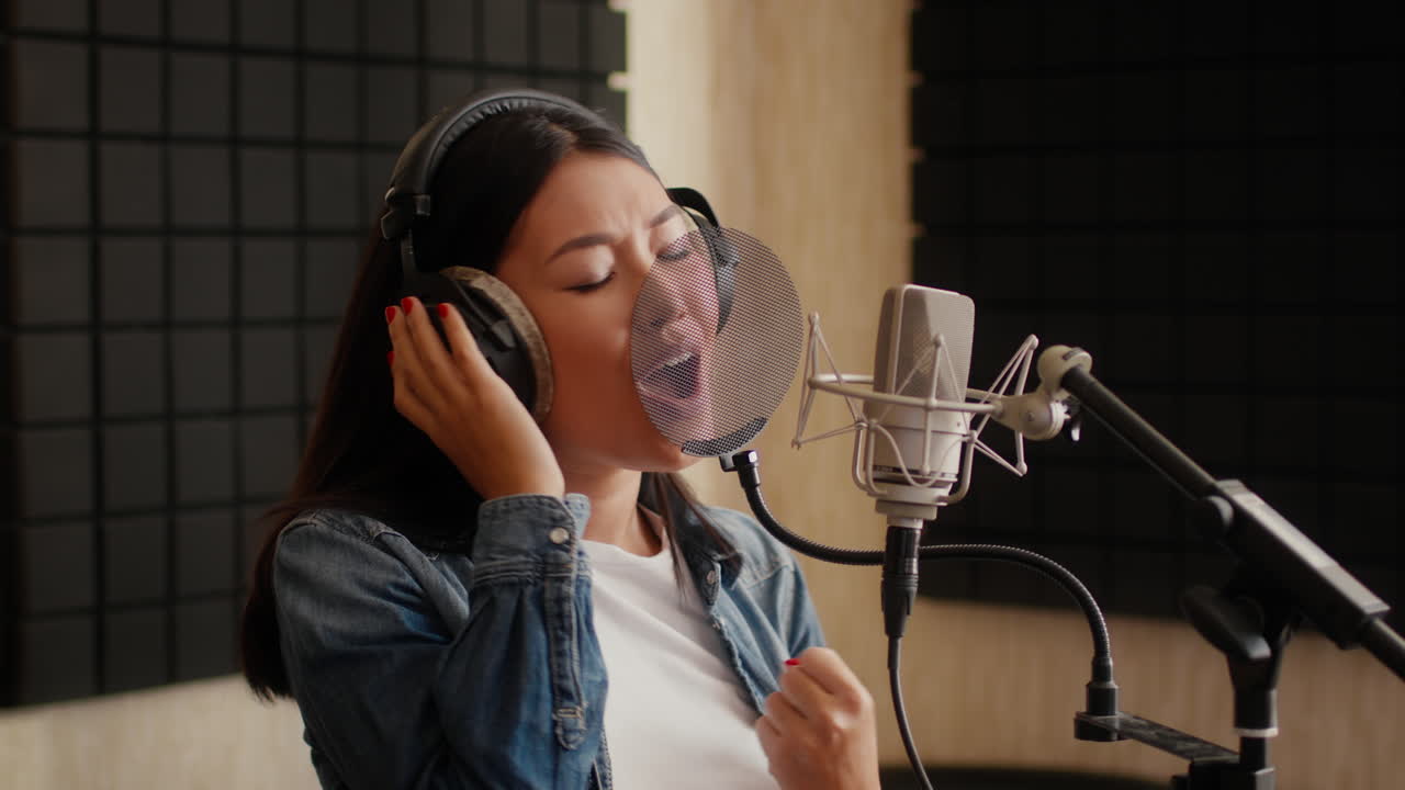 Woman Singing in a Professional Recording Studio