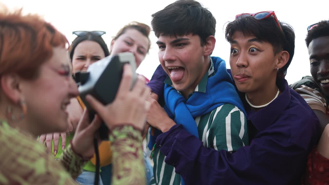 Young diverse people having fun with old vintage photo  camera outdoor