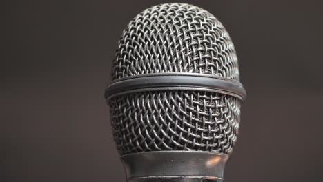 extreme closeup of old dirty stereo microphone head, spinning. macro shot.  scene c.