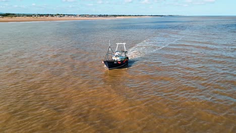 Small-fishing-trawler-boat-ship-sailing-into-the