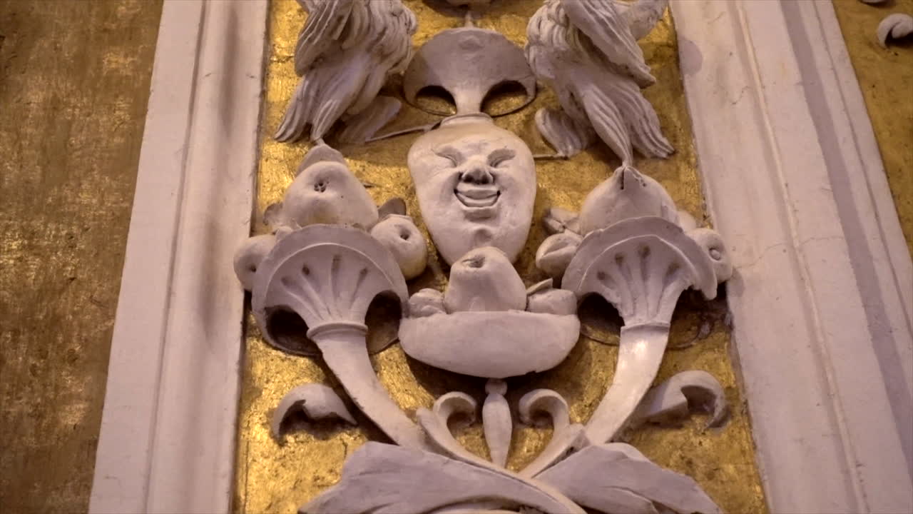 Stuccoes and statues inside the Serpotta Chapel of Castelbuono Castle, Sicily. Angels, devils, and fierce demonic faces decorate this masterpiece, showcasing Baroque artistry at its finest.