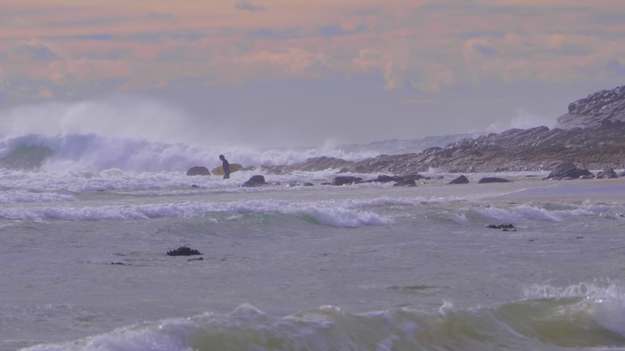 Surfer slowly approaching the waves - Crescent Head NSW  Australia