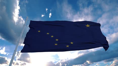 alaska flag on a flagpole waving in the wind in the sky. state of alaska in the united states of america