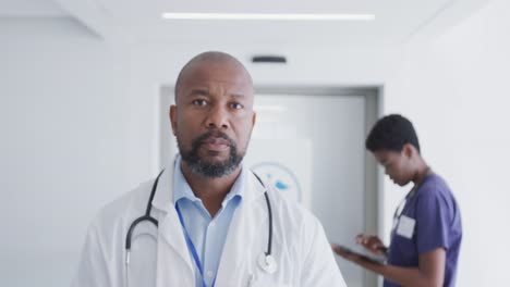 portrait of african american male doctor looking at camera at hospital