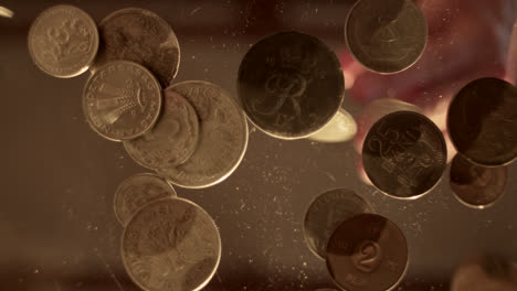 close-up of old european coins on a reflective surface