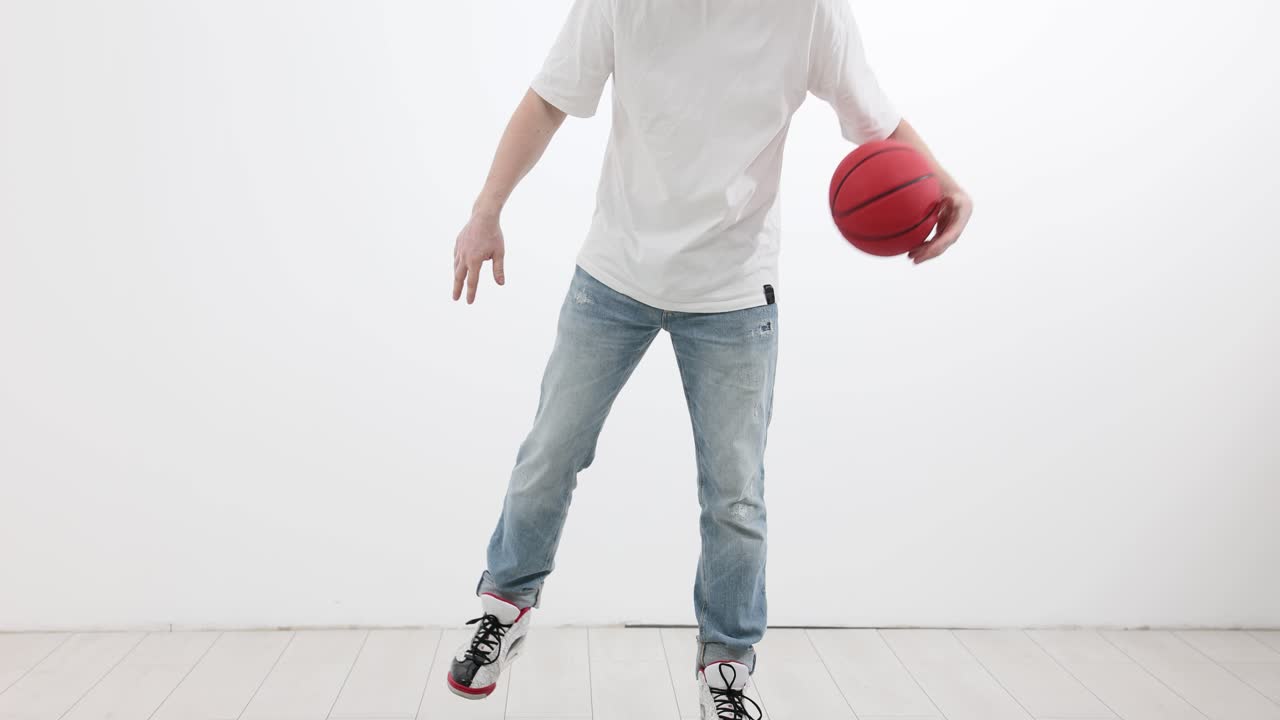 Person Dribbling a Basketball in a Studio