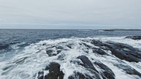 rocky coastline and rough seawater on moody day