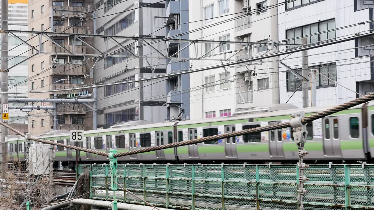 Japanese Train Passing Through City