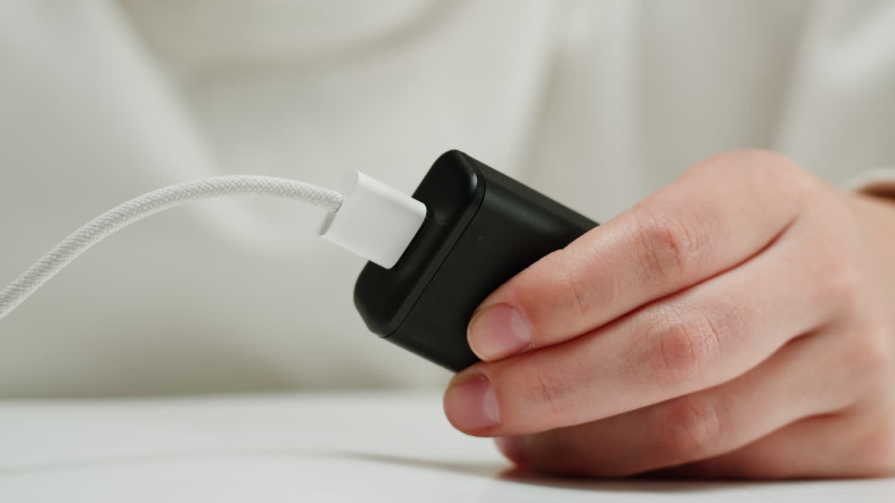 Connecting wire with usb charger close-up.Tangled wires on table. Chargers for electronic devices