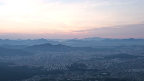 Aerial-landscape-shot-of-Seoul-city-and-surrounding-mountains,-South-Korea