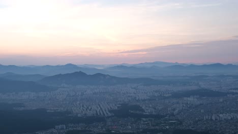 aerial landscape shot of seoul city and surrounding mountains, south korea