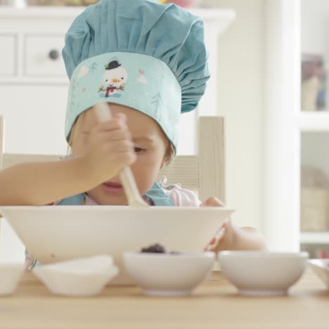 Adorable-serious-toddler-at-mixing-bowl