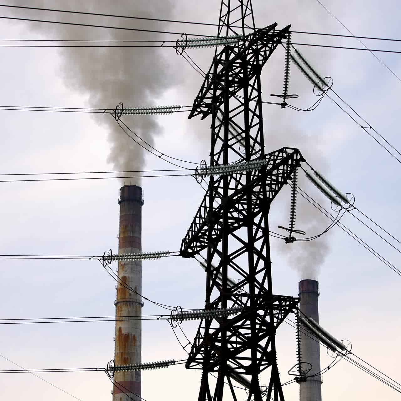 Ecological problems. Transmission lines near the industry. Thick smoke from pipes filling the air. Chemical fumes pollute the atmosphere