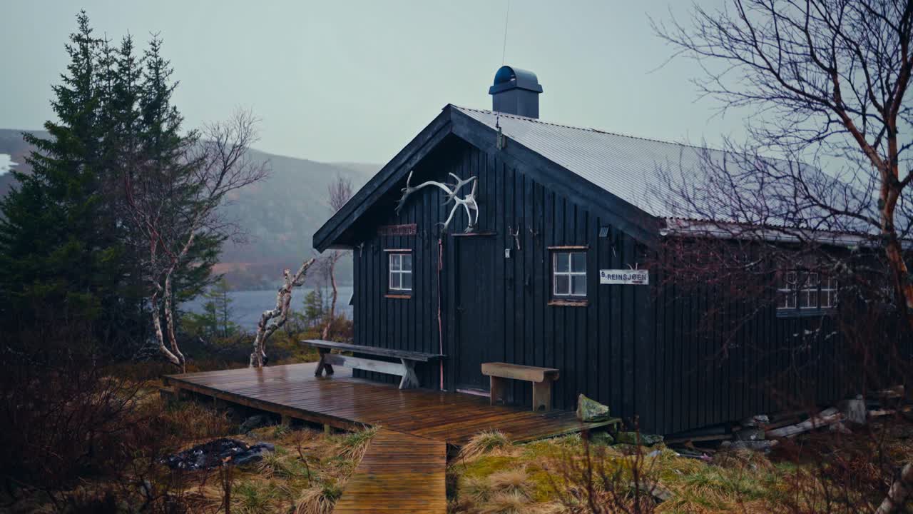 Rain Falls on a Rustic Cabin in Reinsjøen, Åfjord, Trøndelag, Norway - Handheld Shot