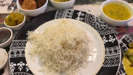 traditional bengali food platter with rice, mutton, chicken, fish, curd, fries served in poila boisakh in kolkata