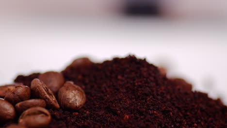 Falling-roasted-coffee-beans-on-ground-coffee-with-blurred-background