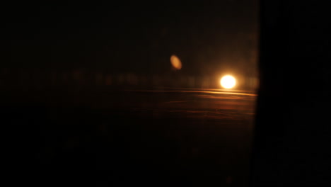 aerial wide shot showing sun in focus at horizon hiding behind airplane window