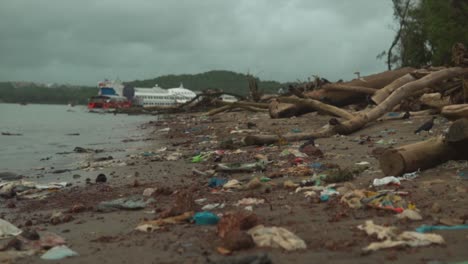 wide shot of a contaminated beach, full of plastic pollution, india, asia